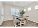 Inviting dining area with a chandelier, table, chairs, and natural light at 913 Deep River Way, Waxhaw, NC 28173