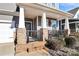 Inviting front entrance features a covered porch with stone columns and decorative details at 913 Deep River Way, Waxhaw, NC 28173