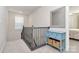 Upstairs landing showcasing stylish iron railings, a window, and a decorative accent table at 913 Deep River Way, Waxhaw, NC 28173