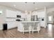 Beautiful kitchen with a large island, white cabinets, stainless steel appliances and hardwood floors at 913 Deep River Way, Waxhaw, NC 28173