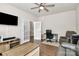 Comfortable living room with ceiling fan, desk, and plush seating, creating a relaxing atmosphere at 913 Deep River Way, Waxhaw, NC 28173