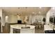Open-concept living space with a kitchen island, dining area, and living room with a fireplace at 913 Deep River Way, Waxhaw, NC 28173