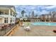 Upscale pool with lounge chairs and umbrellas next to clubhouse create a resort style community gathering place at 913 Deep River Way, Waxhaw, NC 28173