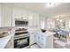 Modern kitchen with white cabinets, stainless steel appliances, and a breakfast bar at 1081 Evergreen Cir, Rock Hill, SC 29732