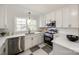 Modern kitchen with white cabinets, stainless steel appliances, and quartz countertops at 1081 Evergreen Cir, Rock Hill, SC 29732