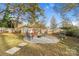 Backyard with fire pit, seating area, and storage shed at 128 Hugh Caldwell Rd, Charlotte, NC 28214