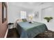 Bedroom with a double bed, side table, and dark wood floors at 128 Hugh Caldwell Rd, Charlotte, NC 28214