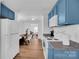 Renovated kitchen with blue cabinets and modern appliances at 128 Hugh Caldwell Rd, Charlotte, NC 28214