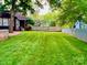 Expansive backyard featuring a lush lawn and bordered by wood and metal fencing at 13538 Pine Harbor Rd, Charlotte, NC 28278