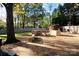 Beautiful backyard featuring a custom stone patio and fire pit, ideal for outdoor gatherings at 13538 Pine Harbor Rd, Charlotte, NC 28278
