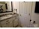 Cozy bathroom featuring a vanity with a white cabinet, marble countertop, and modern fixtures at 13538 Pine Harbor Rd, Charlotte, NC 28278