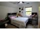 Bright bedroom with a fan, mini refrigerator, plush teddy bears, and a view of the window at 13538 Pine Harbor Rd, Charlotte, NC 28278