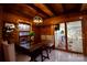 Inviting dining area featuring hardwood floors, rustic wood features, and bright light at 13538 Pine Harbor Rd, Charlotte, NC 28278