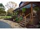 Inviting exterior with a covered porch, lush landscaping, and a stone walkway at 13538 Pine Harbor Rd, Charlotte, NC 28278