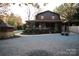 Attractive two-story home featuring a covered porch and a spacious gravel driveway at 13538 Pine Harbor Rd, Charlotte, NC 28278