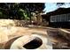 Spacious backyard with flagstone patio, fire pit, and an outdoor kitchen area at 13538 Pine Harbor Rd, Charlotte, NC 28278