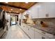 Stylish kitchen featuring white cabinets, stainless steel appliances and wood ceiling at 13538 Pine Harbor Rd, Charlotte, NC 28278