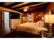 Cozy main bedroom features a queen-size bed, wood walls, and unique lighting at 13538 Pine Harbor Rd, Charlotte, NC 28278