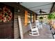 Charming covered porch with rocking chairs, a 'Welcome' sign, and inviting decor at 13538 Pine Harbor Rd, Charlotte, NC 28278