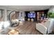 Spacious recreation room featuring natural light, a large television, a recliner, and hammock seating at 13538 Pine Harbor Rd, Charlotte, NC 28278