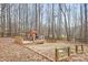 Backyard area with playhouse and mature trees at 141 Byers Rd, Troutman, NC 28166