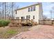 Home's backyard featuring a deck, fence, and brick patio at 141 Byers Rd, Troutman, NC 28166