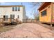 View of the backyard featuring a gate, playhouse, and brick patio at 141 Byers Rd, Troutman, NC 28166