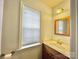 Small bathroom with updated vanity, gold fixtures, and window at 141 Byers Rd, Troutman, NC 28166