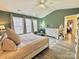 Main bedroom with king-size bed, green walls, and large windows at 141 Byers Rd, Troutman, NC 28166