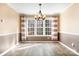 Dining room with a decorative chandelier, wainscoting, and large windows for natural light at 141 Byers Rd, Troutman, NC 28166