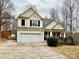 Two-story house with a large driveway and landscaping at 141 Byers Rd, Troutman, NC 28166