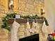 Fireplace mantel decorated with stockings and greenery at 141 Byers Rd, Troutman, NC 28166