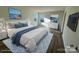 Virtually staged main bedroom with large bed and dresser at 164 Wildwood Loop, Statesville, NC 28677