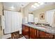 Well-lit bathroom features dual sinks, granite countertops, and a shower-tub combo for a functional and stylish design at 210 N Church St # 2702, Charlotte, NC 28202