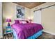 Bright bedroom featuring a sliding barn door, purple bedding, and a vibrant Marilyn Monroe art piece on the wall at 210 N Church St # 2702, Charlotte, NC 28202