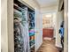 Organized walk-in closet filled with shelving and hanging racks, leading into a bathroom for added convenience at 210 N Church St # 2702, Charlotte, NC 28202