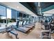 Modern gym with treadmills, fitness machines, and large windows with city views at 210 N Church St # 2702, Charlotte, NC 28202