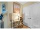 Hallway decor featuring a console table, modern lamps, decorative vases and wall art beside double doors at 210 N Church St # 2702, Charlotte, NC 28202