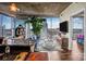 Modern living room with floor-to-ceiling windows and a large potted plant, showcasing cityscape views and contemporary decor at 210 N Church St # 2702, Charlotte, NC 28202