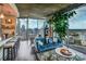 Bright living room with floor-to-ceiling windows and cityscape views, featuring a stylish blue sofa and modern decor at 210 N Church St # 2702, Charlotte, NC 28202