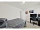 Functional bedroom features a comfortable bed and a desk for workspace, illuminated by overhead lighting at 2117 Talbert Ct, Charlotte, NC 28214