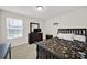 Comfortable bedroom with a dark wood frame bed, dresser, and natural light from the window at 2117 Talbert Ct, Charlotte, NC 28214