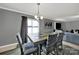 Sunlit dining area features a wooden table and seating for four, with sliding glass door and chandelier at 2117 Talbert Ct, Charlotte, NC 28214