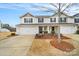 Charming townhome featuring an attached garage and a well-maintained front yard with tasteful landscaping at 2117 Talbert Ct, Charlotte, NC 28214