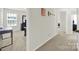 Hallway featuring views of bedrooms and a desk, with natural light from the window at 2117 Talbert Ct, Charlotte, NC 28214