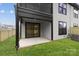 A covered patio in backyard showing a modern exterior with black trim and grassy space at 2205 Catalina Ave, Charlotte, NC 28206