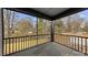 Open porch showcasing the wooden floors with iron railing, offering a view of the surrounding landscape at 2205 Catalina Ave, Charlotte, NC 28206