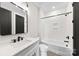 Bright bathroom with white marble countertop, sleek black fixtures, and a shower-tub combo at 2205 Catalina Ave, Charlotte, NC 28206