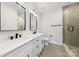 Modern bathroom with a double sink vanity, quartz countertop, and a glass door shower at 2205 Catalina Ave, Charlotte, NC 28206