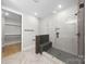 Modern bathroom with a walk-in shower, herringbone tile floor, and built-in shelves at 2205 Catalina Ave, Charlotte, NC 28206